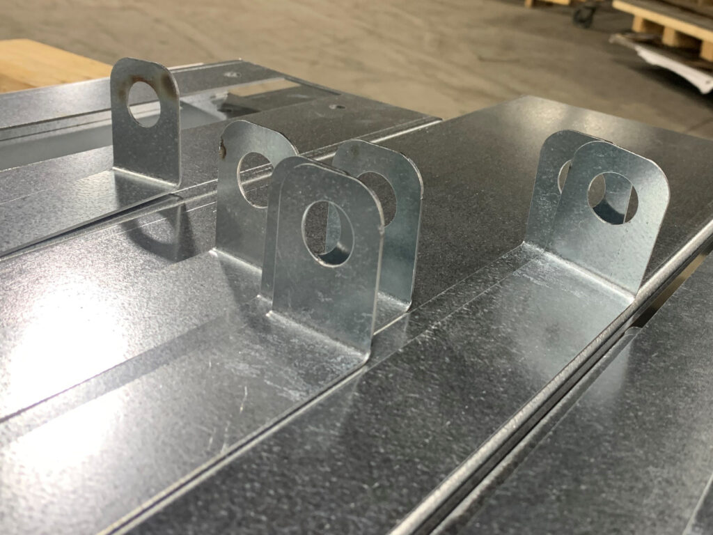 Metal components formed by The Welmar Group's laser cutter.